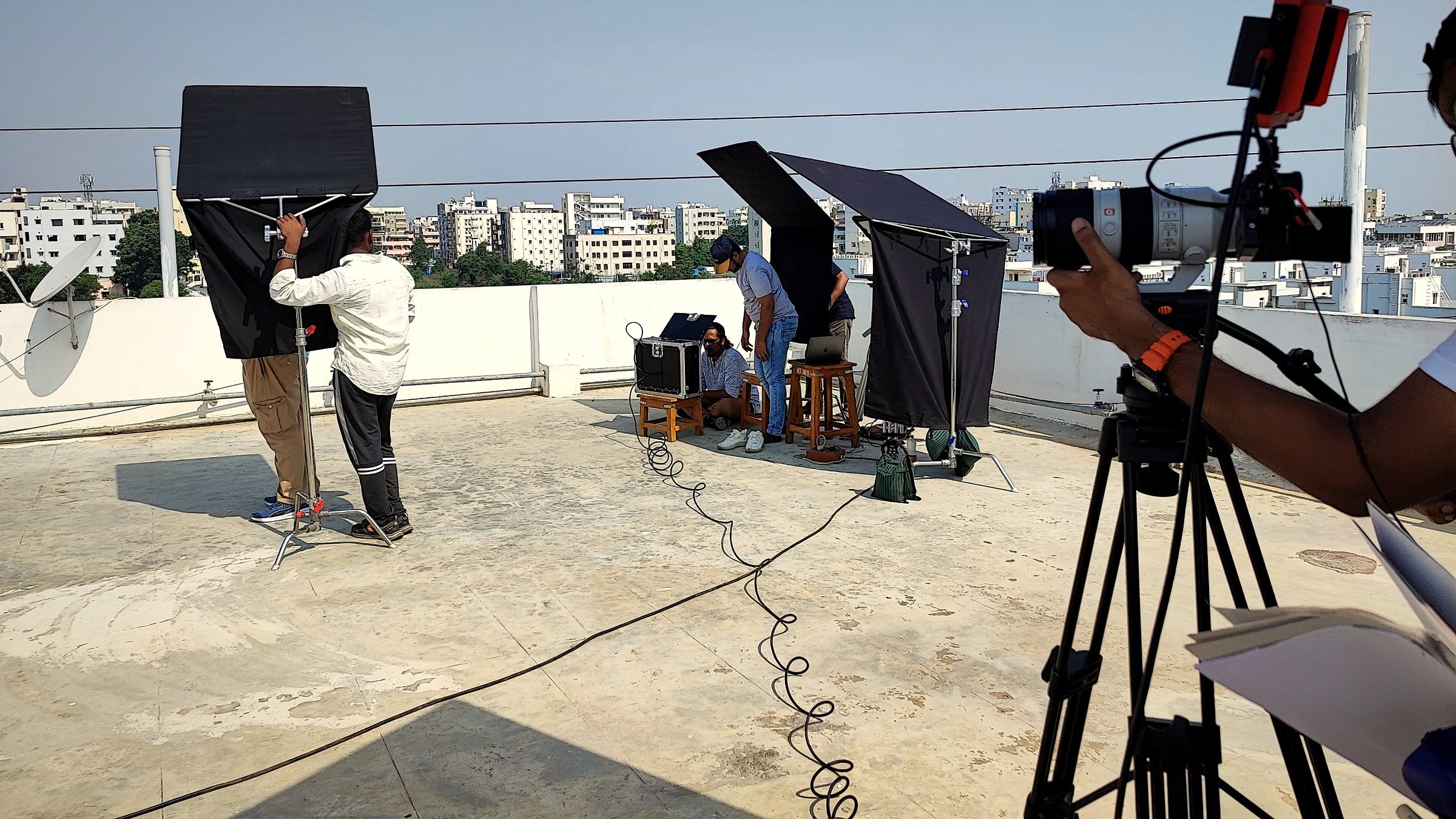 Fotilo Films crew setting up lights and a cinema camera for a rooftop shoot in Hyderabad