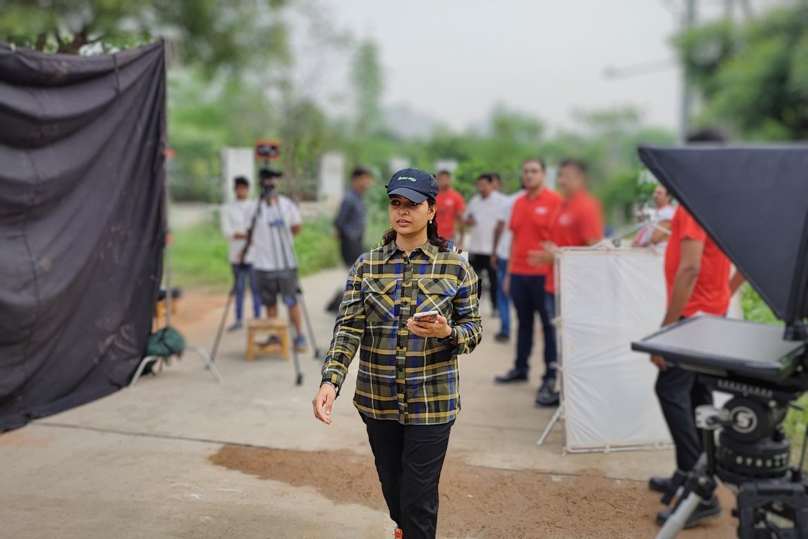Vipasha Kiran of Fotilo Films directing an outdoor shoot with crew and a teleprompter