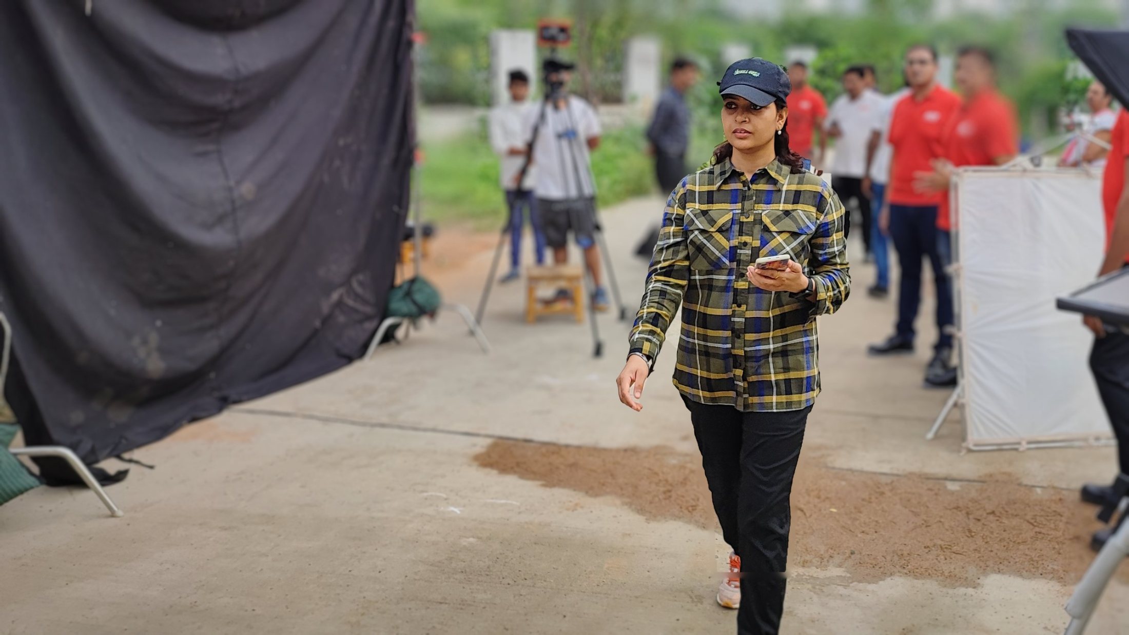 Vipasha Kiran of Fotilo Films directing an outdoor shoot with crew and a teleprompter